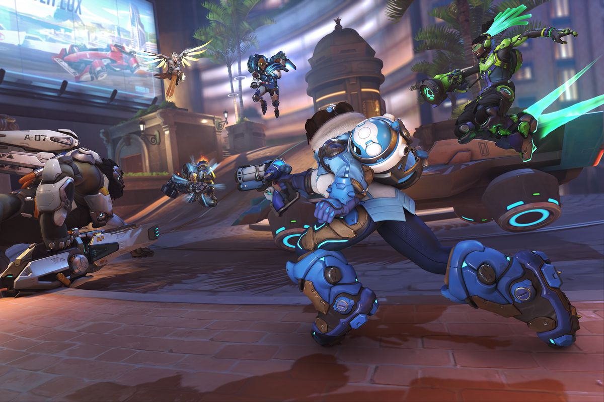 Winston, Reinhardt, Mercy, Pharah, Mei and Lucio battle in a screenshot from Overwatch 2
