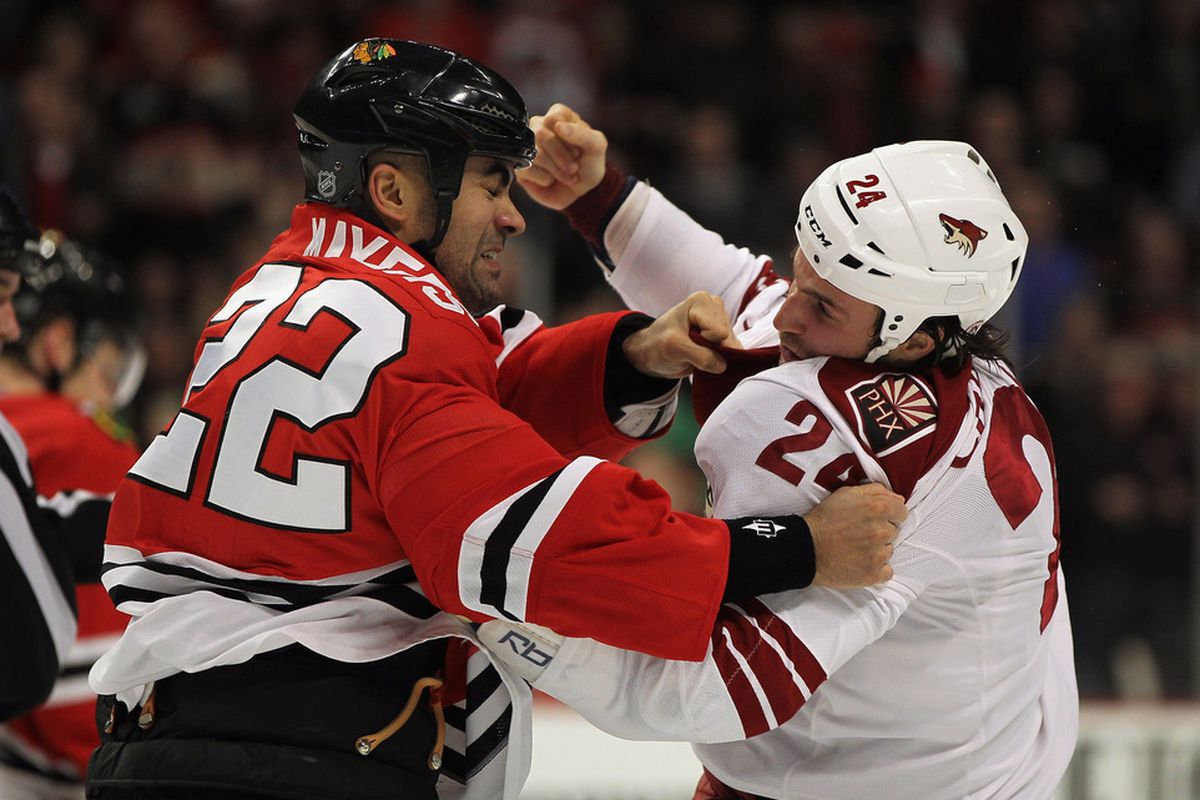 DECEMBER 05:  Jamal Mayers #22 of the Chicago Blackhawks fights with Kyle Chipchura #24 of the Phoenix Coyotes in the second period at the United Center on December 5, 2011 in Chicago, Illinois.  (Photo by Jonathan Daniel/Getty Images)