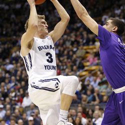Brigham Young Cougars guard Tyler Haws (3) shoots over Bryce Pressley as Brigham Young University plays Portland in NCAA men's basketball Monday, Dec. 29, 2014, in Provo.  
