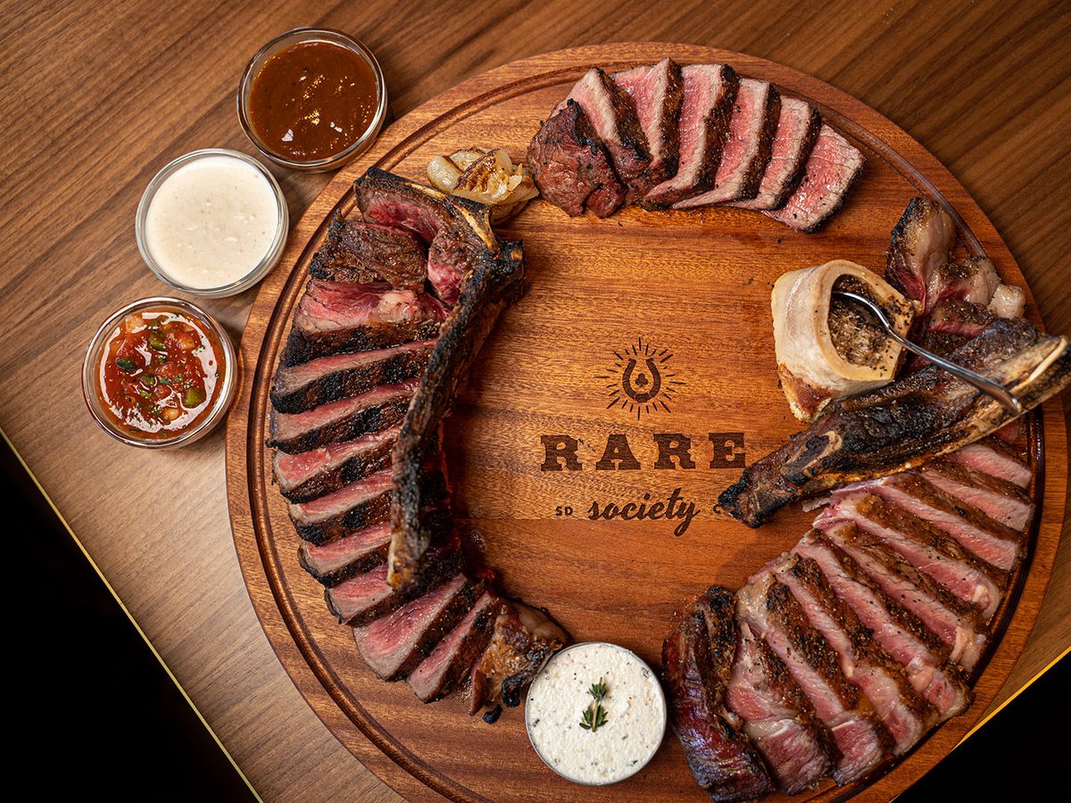 A Rare Society platter with several sliced steaks.
