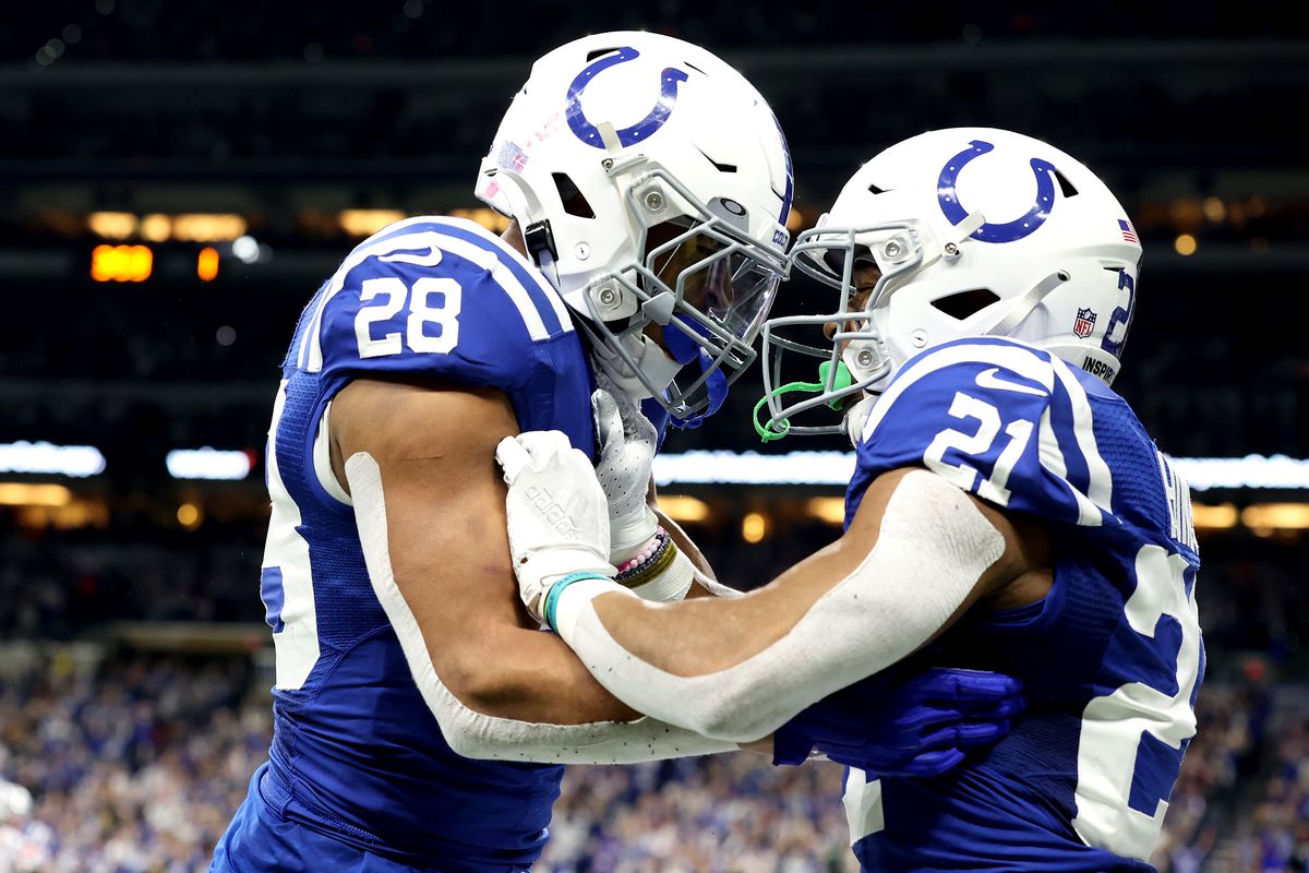 Jonathan Taylor #28 of the Indianapolis Colts and Nyheim Hines #21 of the Indianapolis Colts celebrate after a touchdown against the New England Patriots during the first quarter at Lucas Oil Stadium on December 18, 2021 in Indianapolis, Indiana.