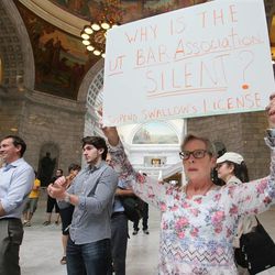 Sue Connor holds a sign as protesters gather at the Capitol rotunda in Salt Lake City Wednesday, June 19, 2013, to protest what they believe is corruption in the Utah Attorney General’s Office.