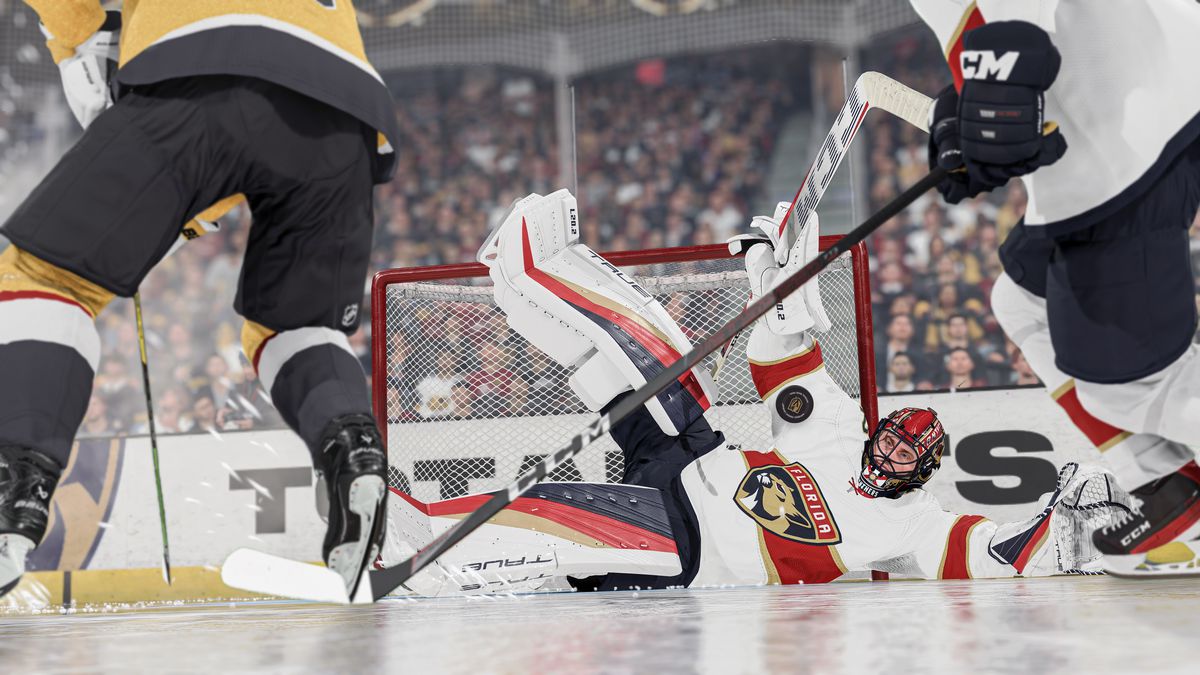 in a screenshot from NHL 24, Florida Panthers goalie Sergei Bobrovsky makes a splayed-out dive to his left along the ice in order to make a save against the Vegas Golden Knights