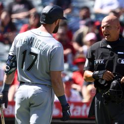 ANAHEIM, CALIFORNIA - SEPTEMBER 19: Mitch Haniger #17 of the Seattle Mariners speaks with umpire Vic Carapazza #19 during the third inning against the Los Angeles Angels at Angel Stadium of Anaheim on September 19, 2022 in Anaheim, California.