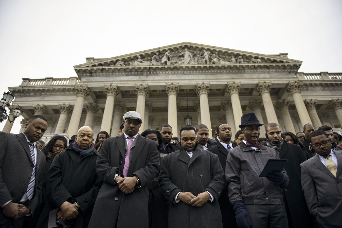 Rep. Elijah Cummings (D-MD) (second from left) stands with African-American Congressional staff members in protest of the Eric Garner and Mike Brown grand jury decisions which did not bring charges against police.