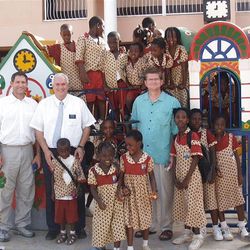 Steve Young, President Robert C. Gay, and Sterling Tanner stand at the Golden Sunbeam School in Adenta, Accra, Ghana.  President Gay was serving as president of the Ghana Accra Mission and is a board member with Forever Young.