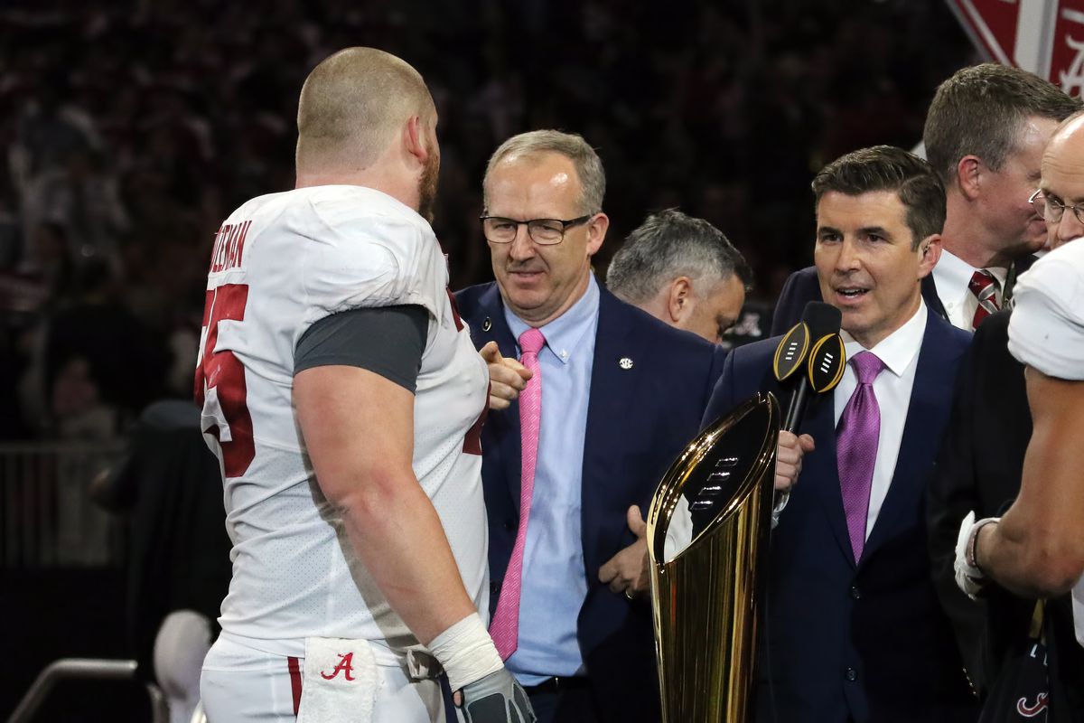 SEC Commissioner Greg Sankey chats with Alabama Crimson Tide offensive lineman Bradley Bozeman after the College Football Playoff National Championship Game.