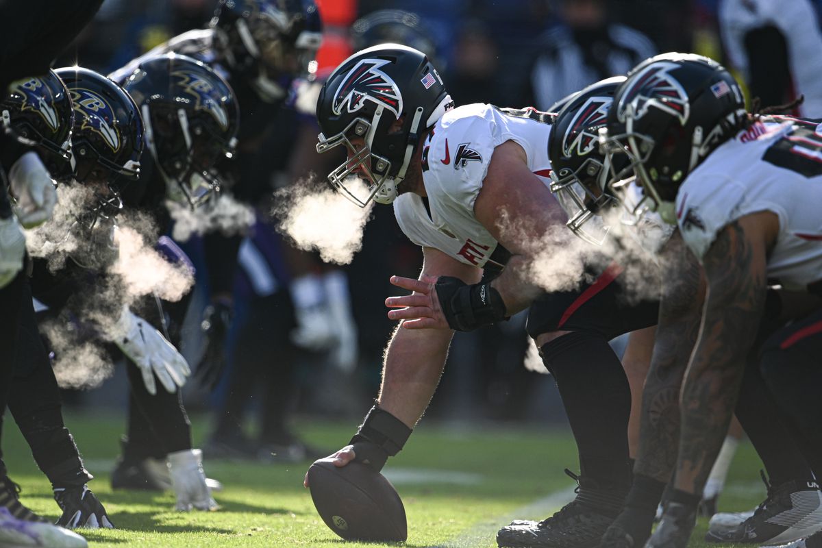 The Falcons offensive line prepares for a play against the Ravens defensive line in Baltimore on December 24, 2022.