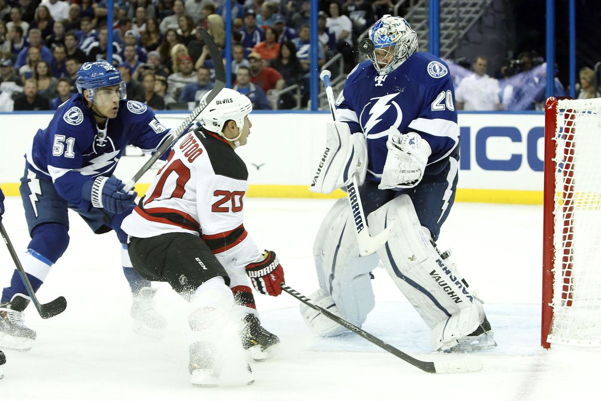 Lightning goalie Evgeni Nabokov makes a save against New Jersey's Jordin Tootoo Tuesday night in Tampa