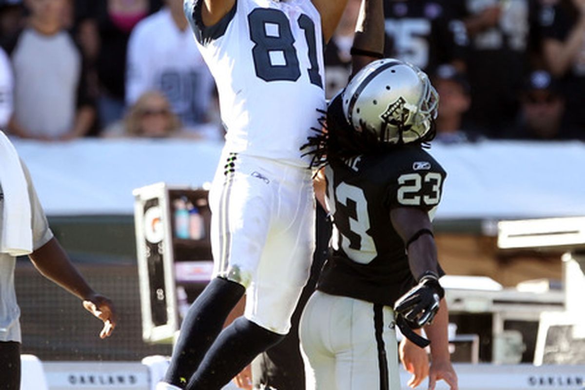 Golden Tate makes a leaping catch over Oakland's Jeremy Ware.