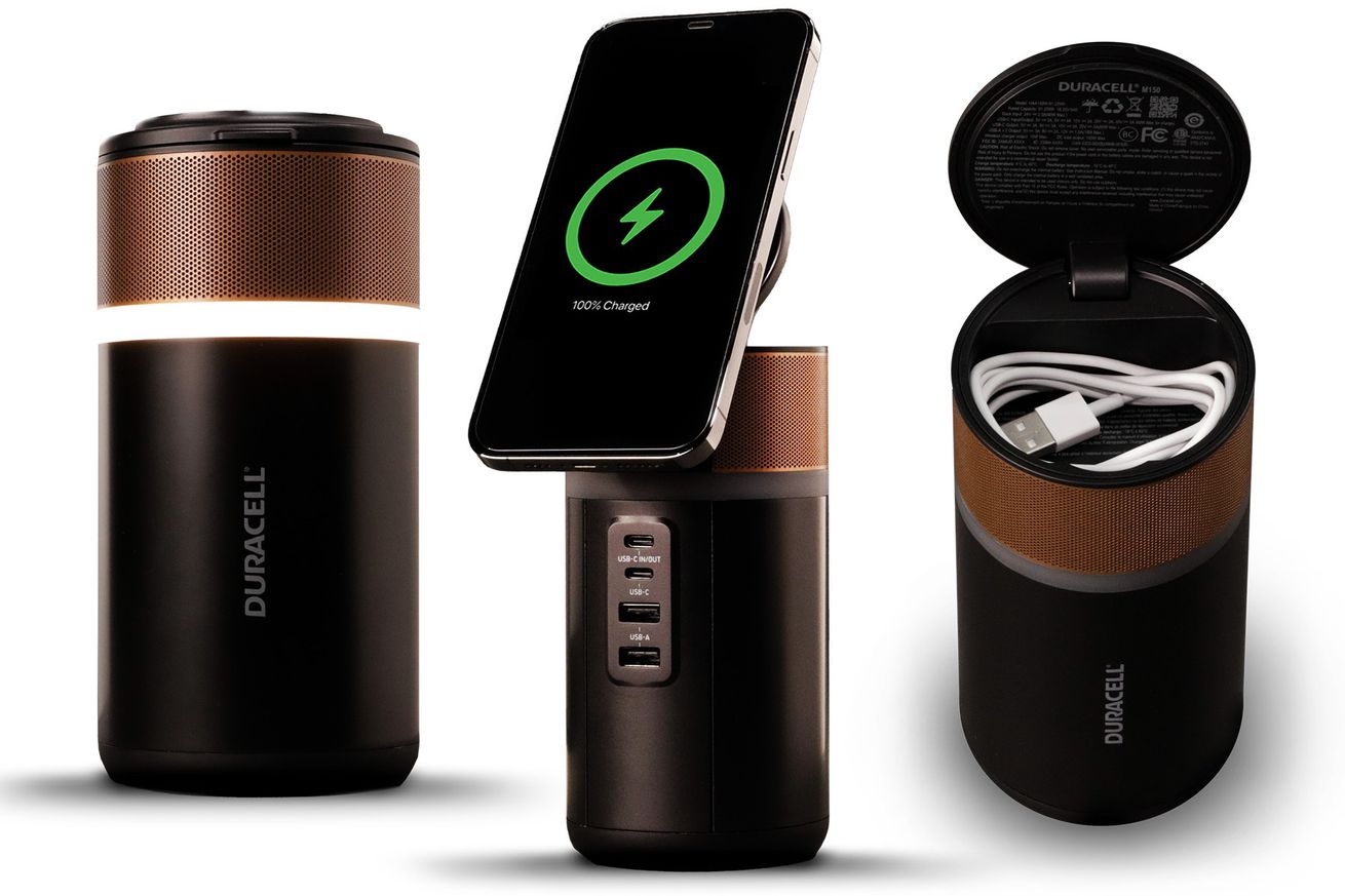 A canister-shaped power tower that looks like a coppertop Duracell battery with four USB ports on the front and a lid that opens to become a wireless charging pad for a phone