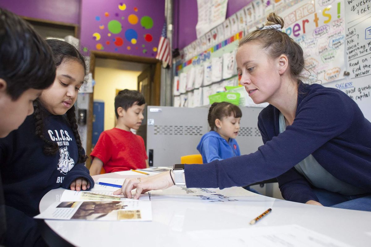 Teacher Kathy McInerney guides students during a small group lesson during class at CICS West Belden.