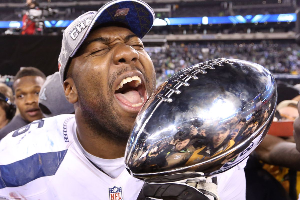 Seattle's Russell Okung celebrates with the Lombardi Trophy Sunday night