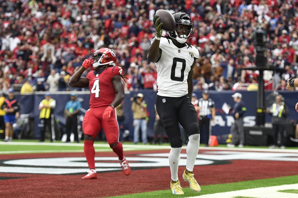 Calvin Ridley #0 of the Jacksonville Jaguars reacts after scoring a touchdown during the third quarter against the Houston Texans at NRG Stadium on November 26, 2023 in Houston, Texas.