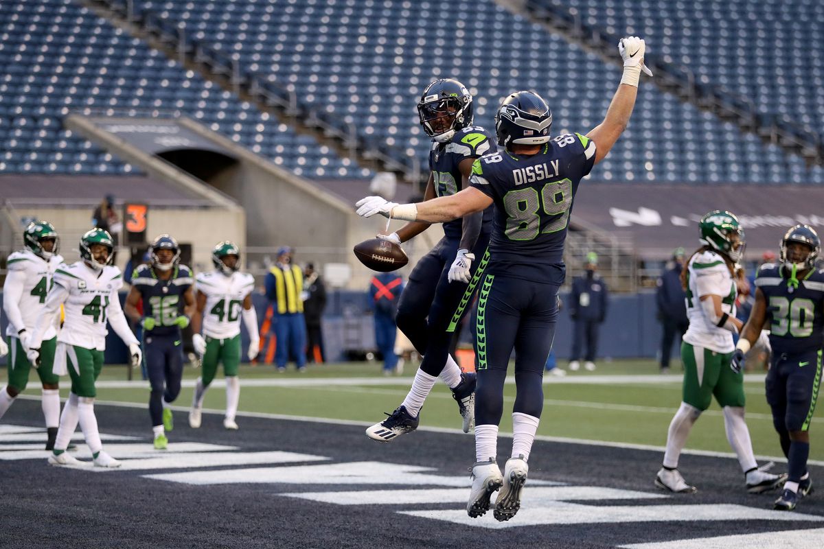 David Moore #83 of the Seattle Seahawks celebrates with Will Dissly #89 after scoring a 3 yard touchdown against the New York Jets during the third quarter in the game at Lumen Field on December 13, 2020 in Seattle, Washington.