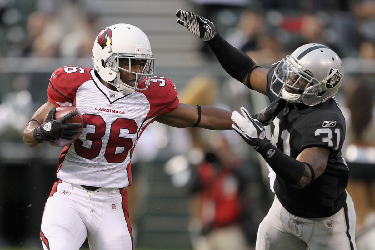 OAKLAND, CA - AUGUST 11:  LaRod Stephens-Howling #36 of the Arizona Cardinals tries to avoid being tackled by Hiram Eugene #31 of the Oakland Raiders at O.co Coliseum on August 11, 2011 in Oakland, California.  (Photo by Ezra Shaw/Getty Images)