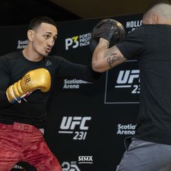 Max Holloway throws a punch at UFC 231 workouts.