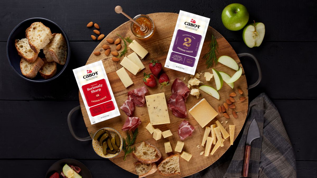 A cheese board with Cabot Cheddar cheeses