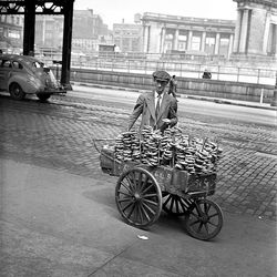 A pretzel vendor displays his wares, well-salted and five cents each, on an approach to the Manhattan Bridge in New York City, April 29, 1948.