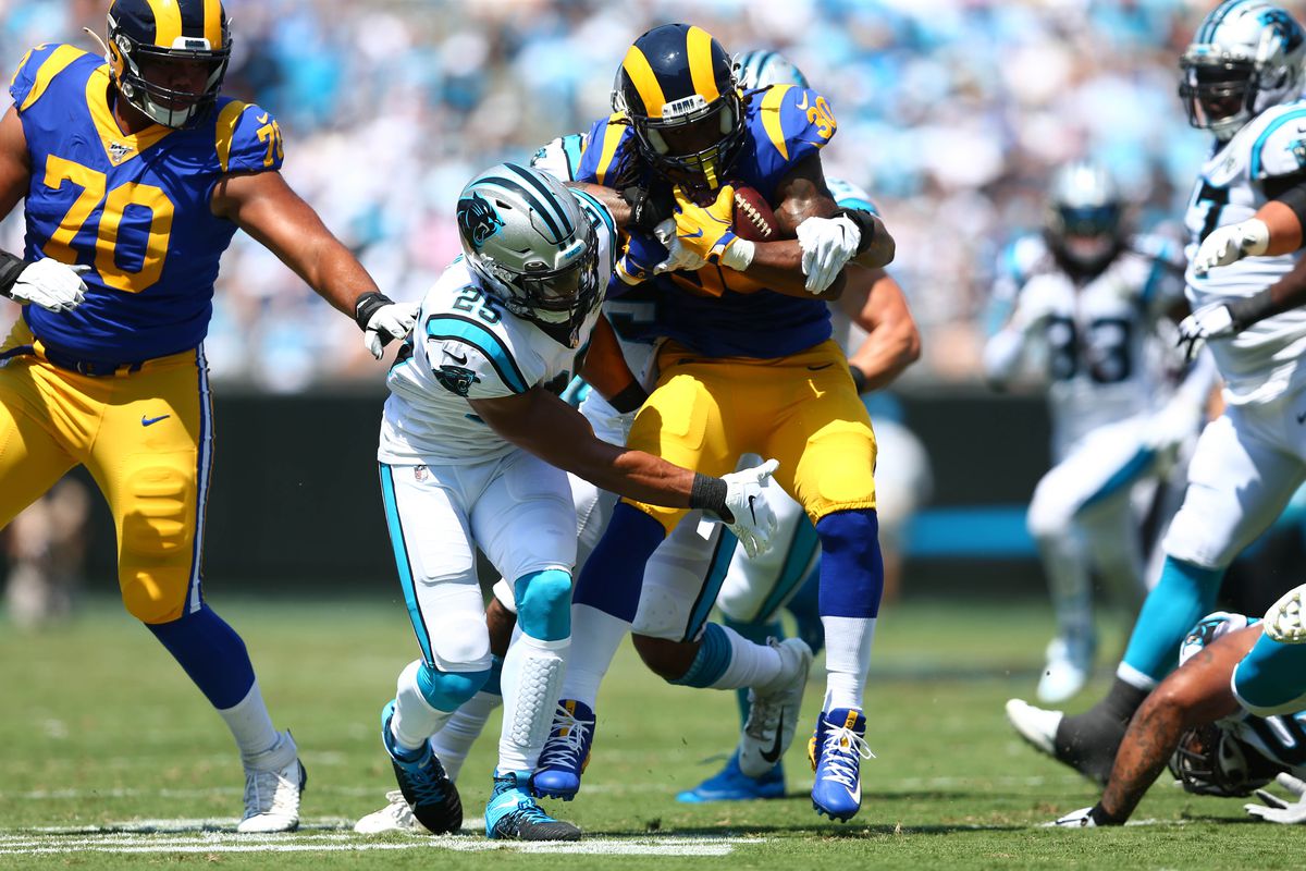 Los Angeles Rams RB Todd Gurley is tackled by Carolina Panthers S Eric Reid and OLB Shaq Thompson in Week 1, Sep. 8, 2019.