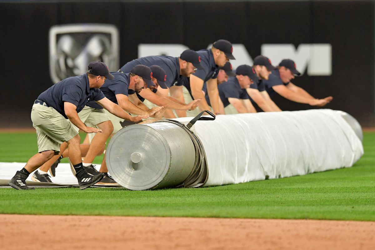 The Cleveland Indians grounds crew rolls out the tarp in preparation for a rain delay during the second inning of the game against the Minnesota Twins at Progressive Field on September 13, 2019 in Cleveland, Ohio.