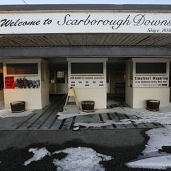 A sign welcomes race fans to the Scarborough Downs harness racing track, Wednesday, Jan. 10, 2018, in Scarborough, Maine. The track is one of two Maine suitors trying to lure Amazon to the Pine Tree State. (AP Photo/Robert F. Bukaty)