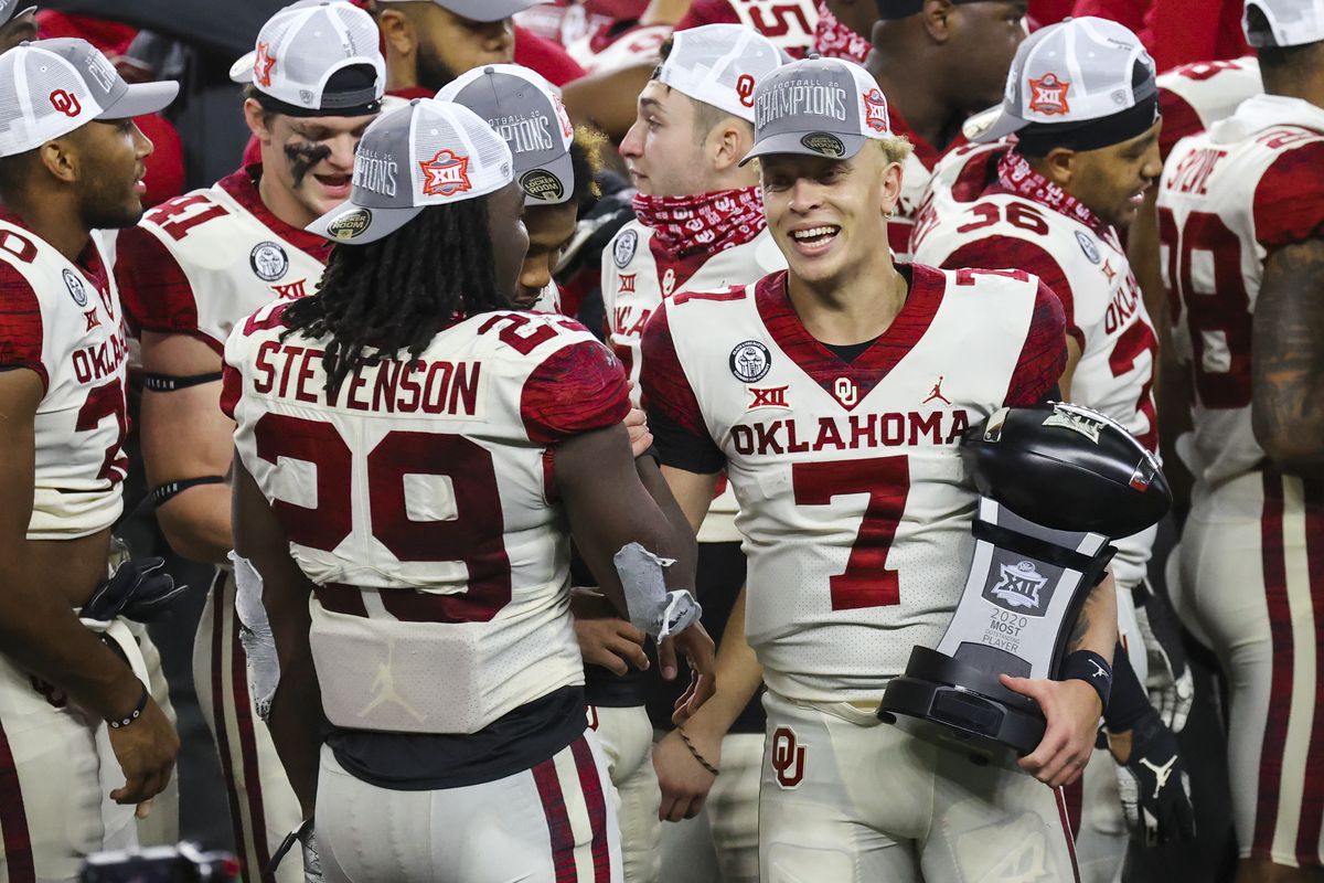 Oklahoma Sooners quarterback Spencer Rattler laughs with running back Rhamondre Stevenson after the game against the Iowa State Cyclones at AT&amp;T Stadium.