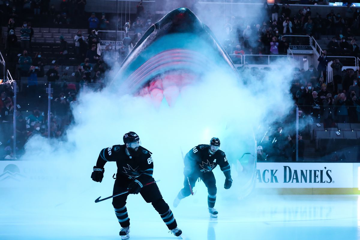 Brent Burns #88 and Tomas Hertl #48 of the San Jose Sharks take the ice through the Shark Head before the game against the Philadelphia Flyers at SAP Center on December 30, 2021 in San Jose, California.
