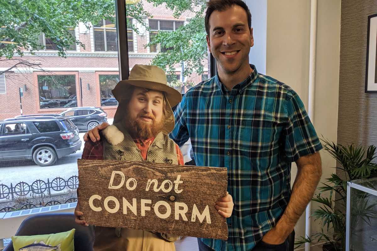 Ross Gordon, founder of Mystery Tackle Box and lCatch Co., poses with the inspired character Karl VonDibble with Randolph Street in the background at Catch Co. headquarters downtown in 2019. Credit: Dale Bowman