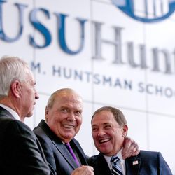 Jon M. Huntsman Sr., center, hugs Utah Gov. Gary R. Herbert during the grand opening of Huntsman Hall at Utah State University on Wednesday, March 16, 2016, in Logan.