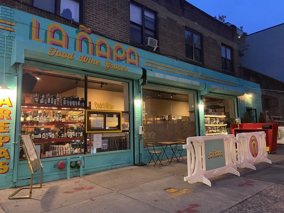 The colorful, blue-and-yellow storefront of La Ñapa, a Latin American restaurant in Crown Heights.