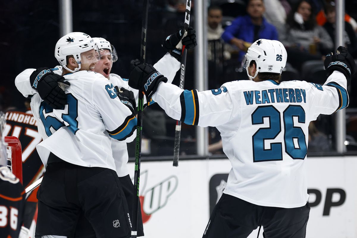 Jasper Weatherby #26 congratulates Jeffrey Viel #63 of the San Jose Sharks after his goal during the second period of a game against the Anaheim Ducks at Honda Center on September 30, 2021 in Anaheim, California.
