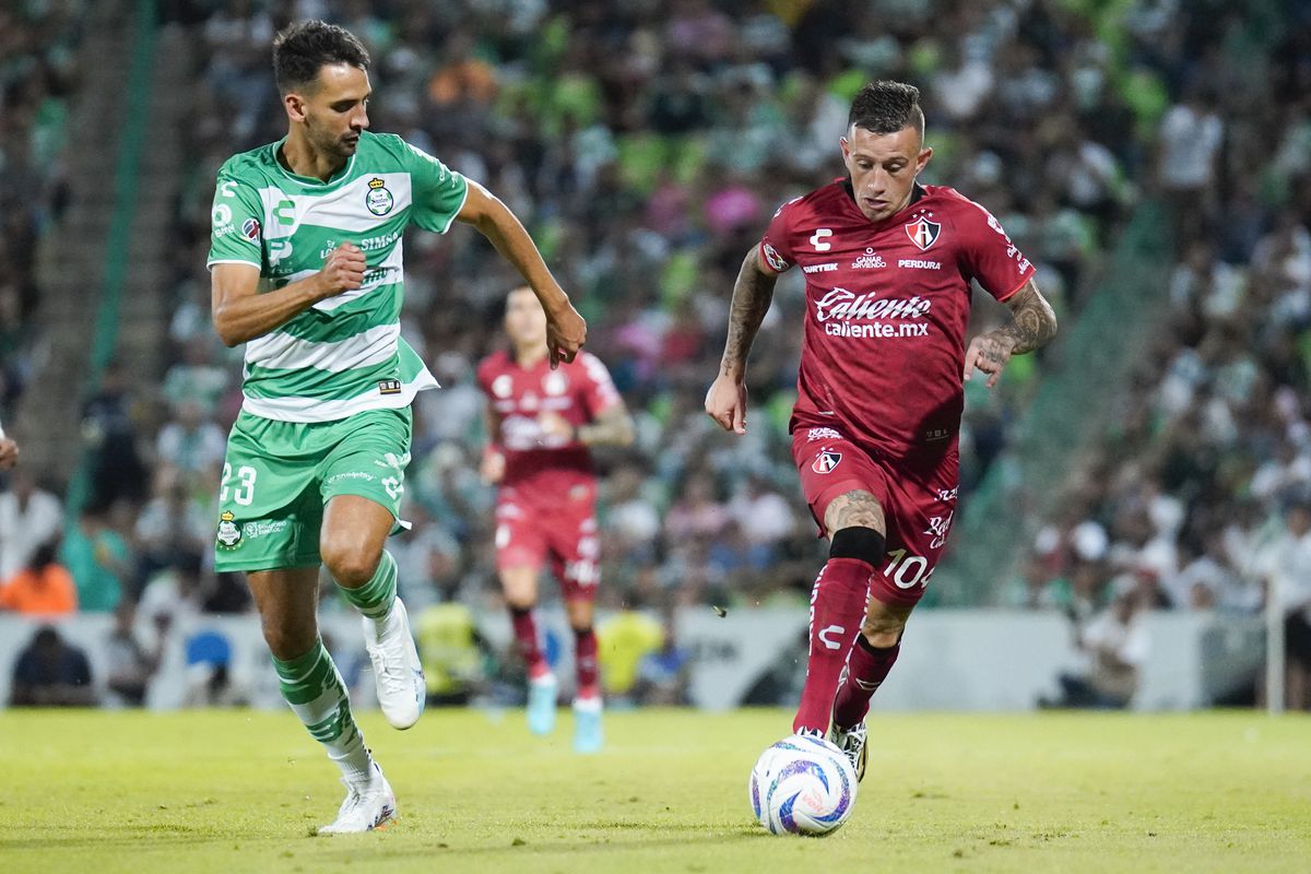 Raul Lopez (L) of Santos fights for the ball with Brian Lozano (R) of Atlas during the 3rd round match between Santos Laguna and Atlas as part of the Torneo Apertura 2023 Liga MX at Corona Stadium on July 13, 2023 in Torreon, Mexico.