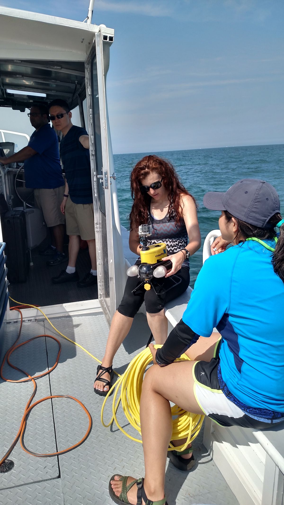 Sabrina Bainbridge of the Shedd Aquarium’s Learning Team holds the ROV before putting it on Morgan Shoal while leader Belle Archaphorn prepares to handle the ROV tether.<br>Credit: Dale Bowman