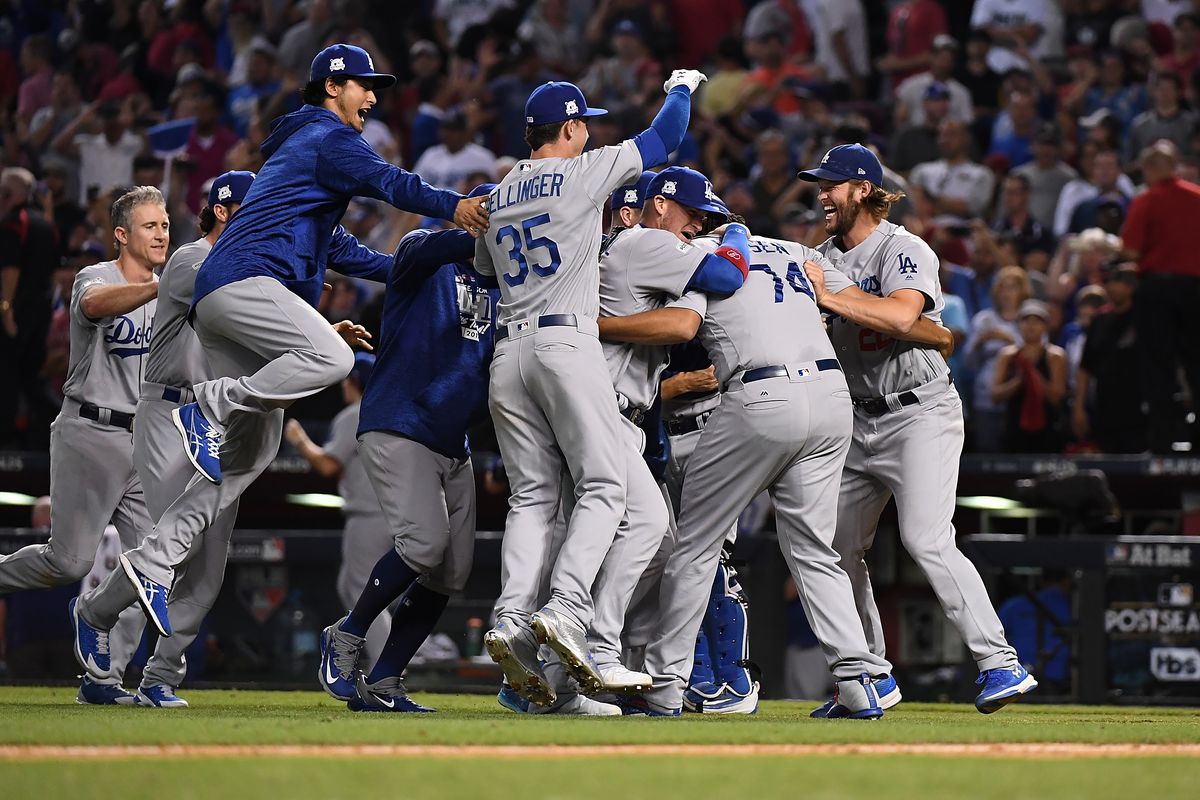 Clayton Kershaw, Kenley Jansen, Yu Darvish, Cody Bellinger and teammates of the Los Angeles Dodgers celebrate a 3-1 win against the Arizona Diamondbacks during game three of the National League Divisional Series at Chase Field on October 9, 2017 in Phoenix, Arizona.