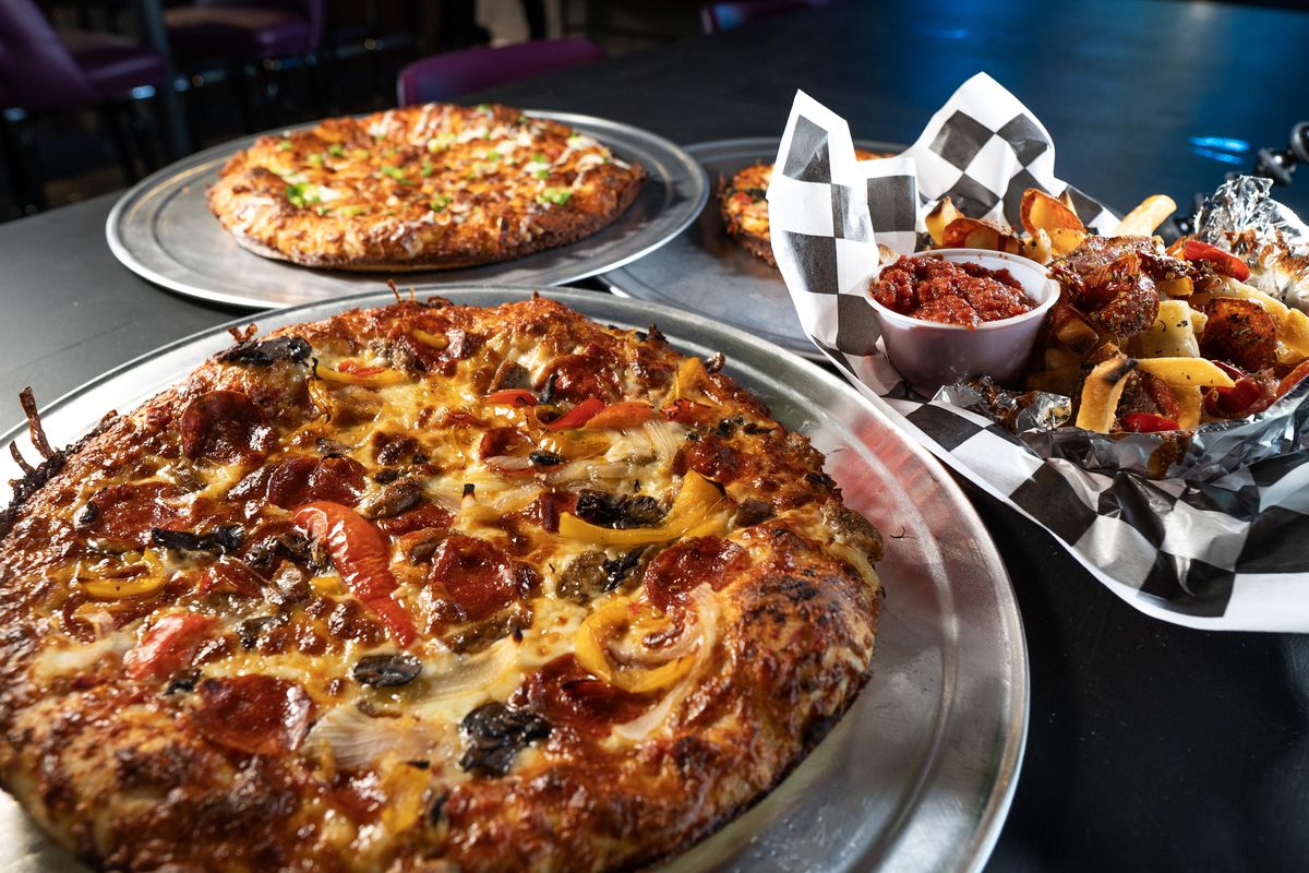 Two ironclad-style pizzas and Pizza fries served with a side of marinara at Betelgeuse Betelgeuse.