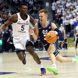 Brigham Young Cougars forward Gideon George (5) defends Utah State Aggies guard Steven Ashworth (3) as BYU and Utah State play an NCAA basketball game in Provo at the Marriott Center on Wednesday, Dec. 8, 2021.