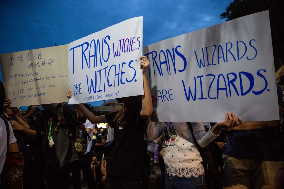 Trans rights banners reading “trans witches are witches” and “trans wizards are wizards” protest J.K. Rowling during anti-government protests In Bangkok