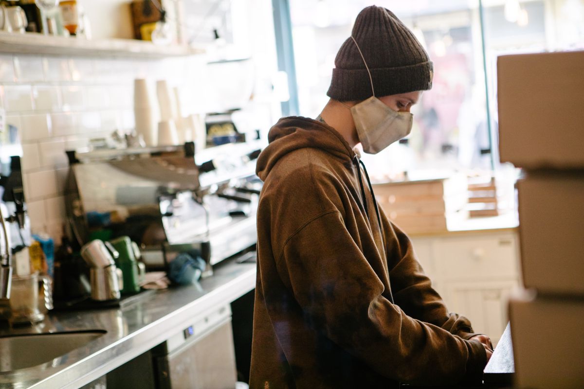 A service staff working behind the counter at Kahaila, a coffee shop