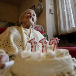 Emma Morano holds a cake with candles marking 117 years in the day of her birthday in Verbania, Italy, Tuesday, Nov. 29, 2016.  At 117 years of age, Emma is now the oldest person in the world and is believed to be the last surviving person in the world who was born in the 1800s, coming into the world on Nov. 29, 1899.