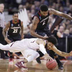 Saint Joseph's forward DeAndre Bembry, bottom, and Cincinnati forward Octavius Ellis (2) go after the ball during the first half of a first-round men's college basketball game in the NCAA Tournament in Spokane, Wash., Friday, March 18, 2016. (AP Photo/Young Kwak)