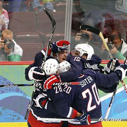 Zach Parise of the United States celebrates with his team after scoring a goal in the third period during the ice hockey men's quarterfinal game against Switzerland Wednesday at the 2010 Winter Olympics in Vancouver. The U.S. team beat Switzerland, 2-0.