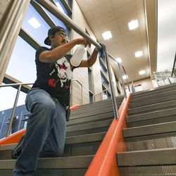 Jaime Chavez, a custodian at Midvale Middle School, disinfects handrails in the school on Monday, March 16, 2020. On Friday Utah Gov. Gary Herbert and state health and education officials closed schools for two weeks to help stop the spread of COVID-19.