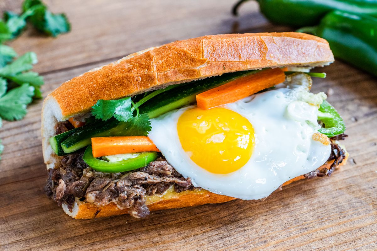 Saigon Hustle’s rib-eye banh mi topped with a fried egg, carrots, jalapeno, and cilantro.