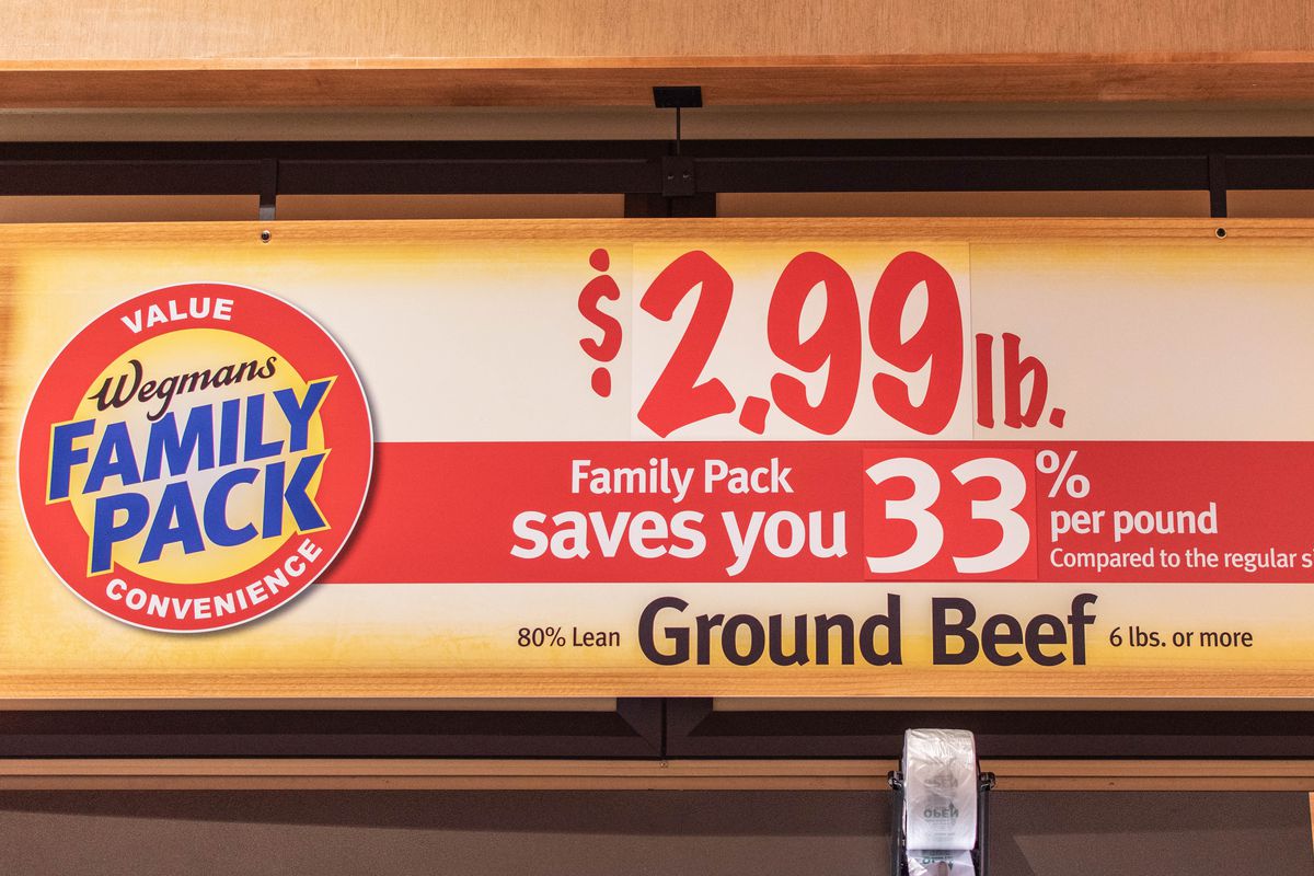 A sign announcing family packs of ground beef for $2.99 per pound
