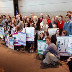 Winners, judges and parents pose with drawings, for the local SunWise with SHADE poster contest, sponsored by the U.S. Environmental Protection Agency. Winners were honored Friday, April 6, 2012, at the Huntsman Cancer Institute.