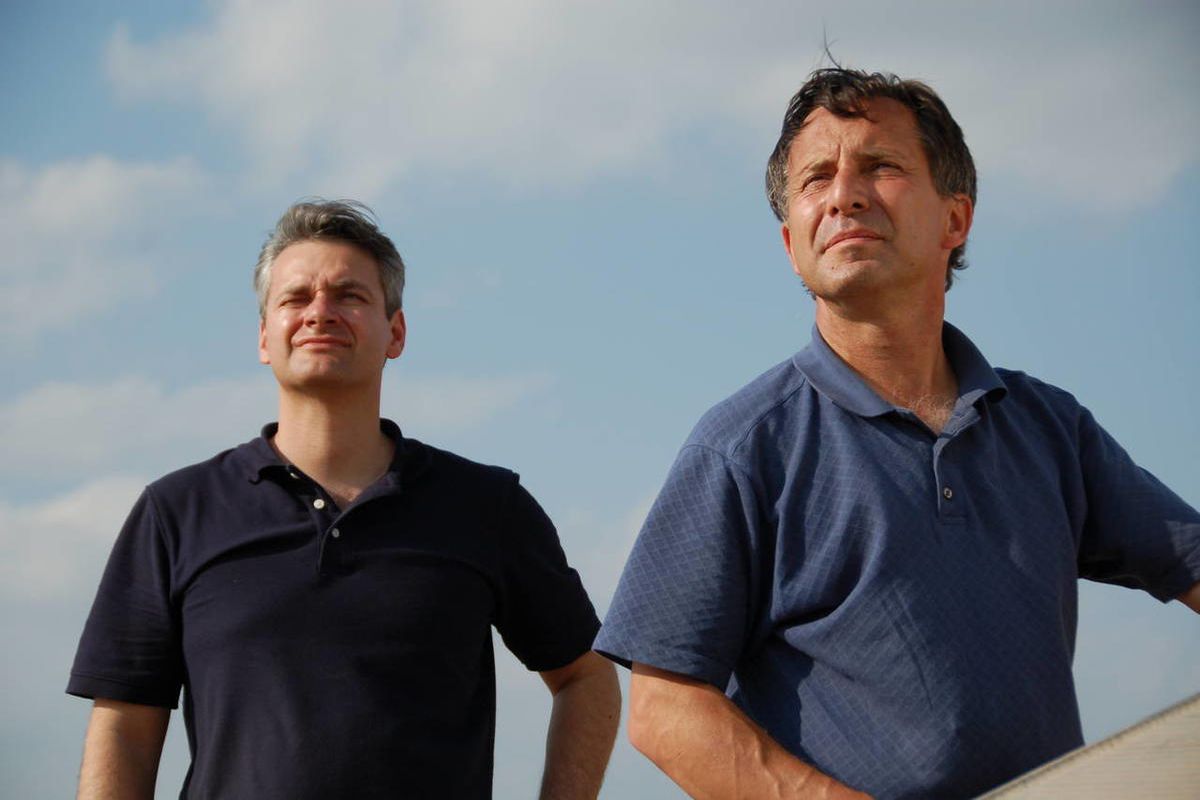 This undated photo provided by The Discovery Channel shows Carl Young, left, and Tim Samaras watching the sky. Jim Samaras said Sunday, June 2, 2013, that his brother storm chaser Tim Samaras was killed along with Tim’s son, Paul Samaras, and another chas