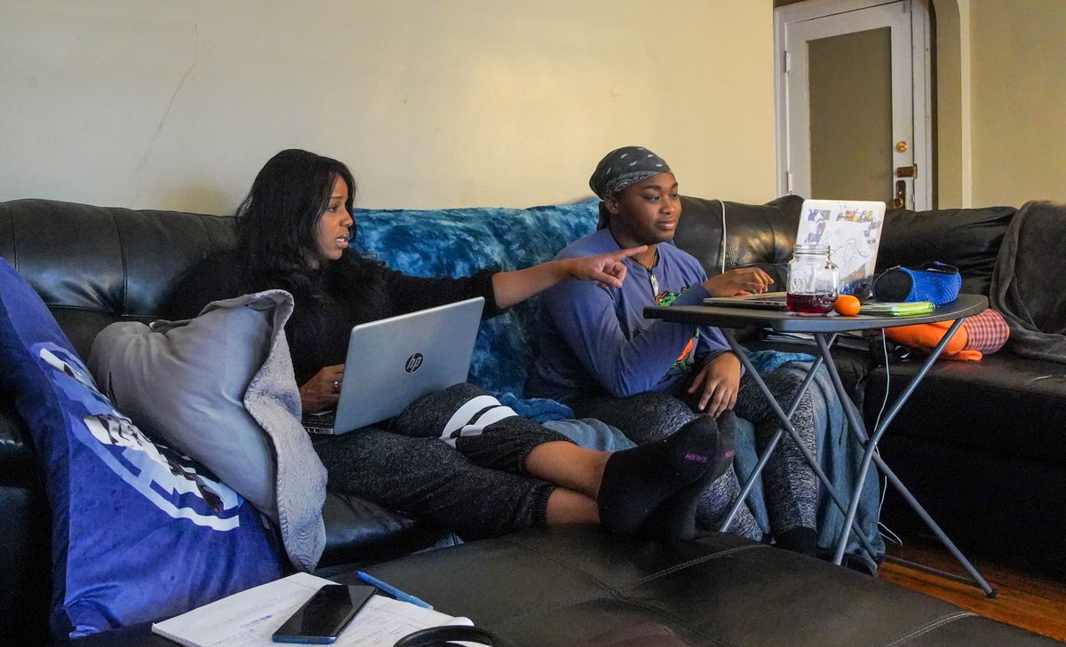 Kim Tyler worked along side her daughter, Madison who was taking an e-learning class from the comfort of their home on Chicago’s south side on Wednesday, April 8, 2020.