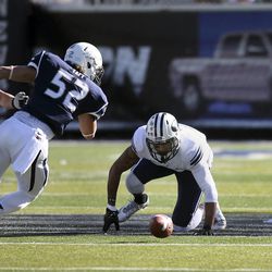 BYU's Cody Hoffman, center, and Nevada's Trevor Taft (52) scramble to recover a fumble during the first half an NCAA college football game in Reno, Nev., on Saturday, Nov. 30, 2013.