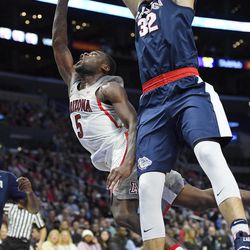 Arizona guard Kadeem Allen, left, shoots as Gonzaga forward Zach Collins defends during the first half of an NCAA college basketball game, Saturday, Dec. 3, 2016, in Los Angeles. 